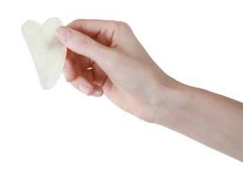 Woman holding gua sha tool on white background, closeup