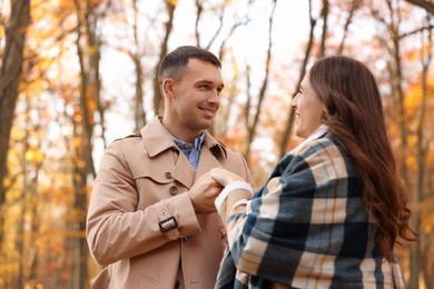 Photo of Happy couple spending time together in autumn park