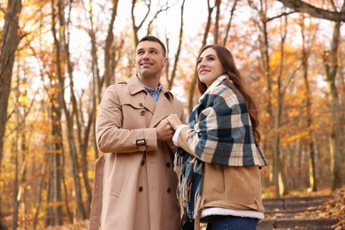 Photo of Happy couple spending time together in autumn park