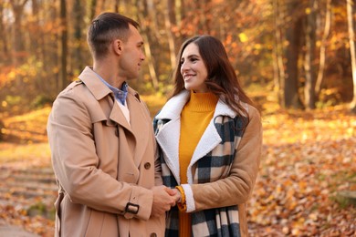 Photo of Happy couple spending time together in autumn park