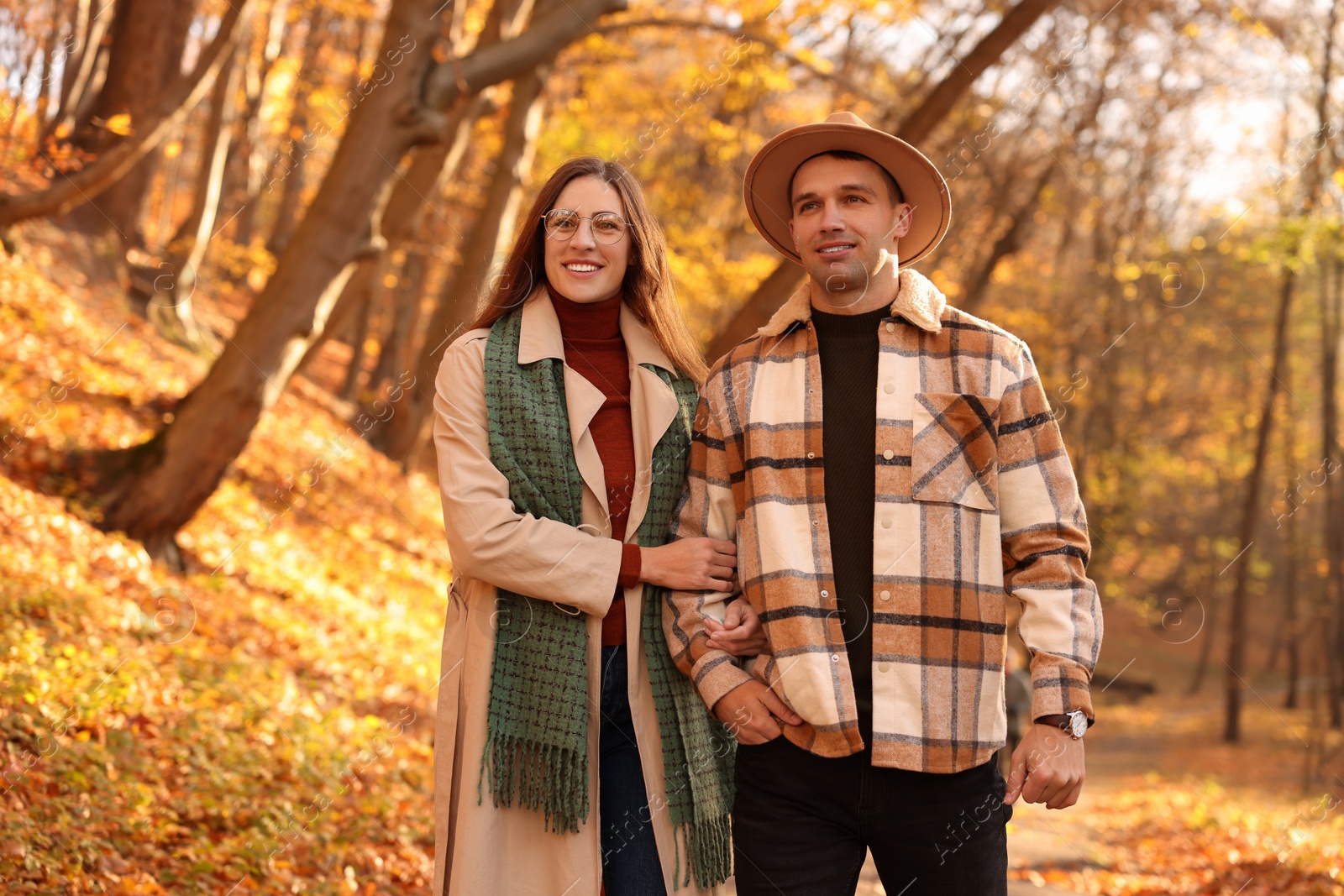 Photo of Happy couple spending time together in autumn park