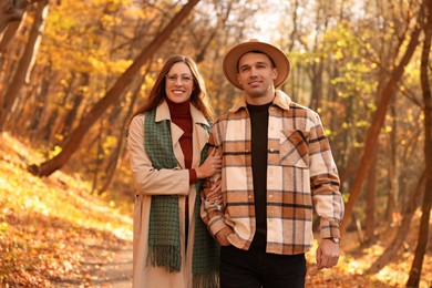 Photo of Happy couple spending time together in autumn park