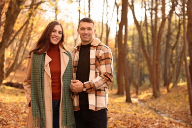 Photo of Happy couple spending time together in autumn park