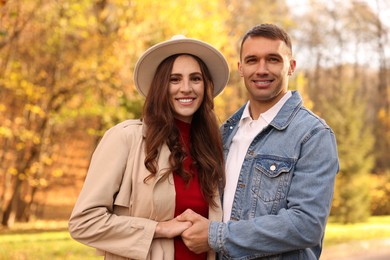 Photo of Happy couple spending time together in autumn park