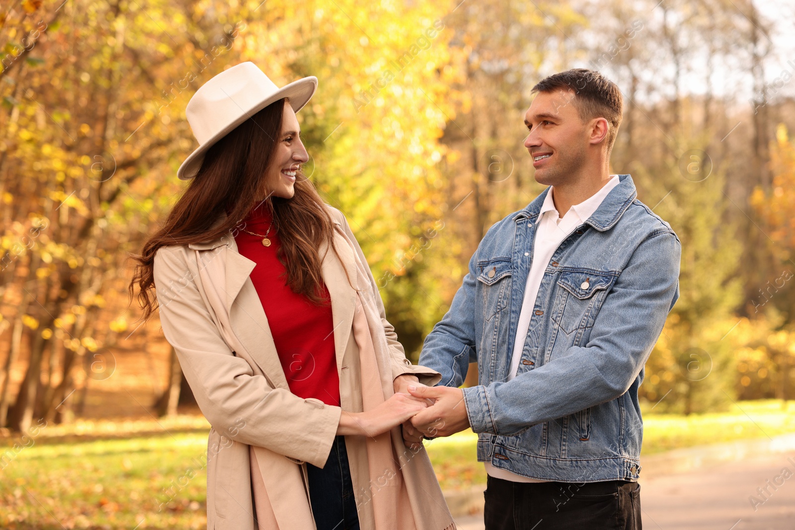 Photo of Happy couple spending time together in autumn park