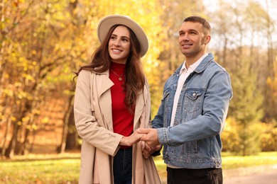 Happy couple spending time together in autumn park