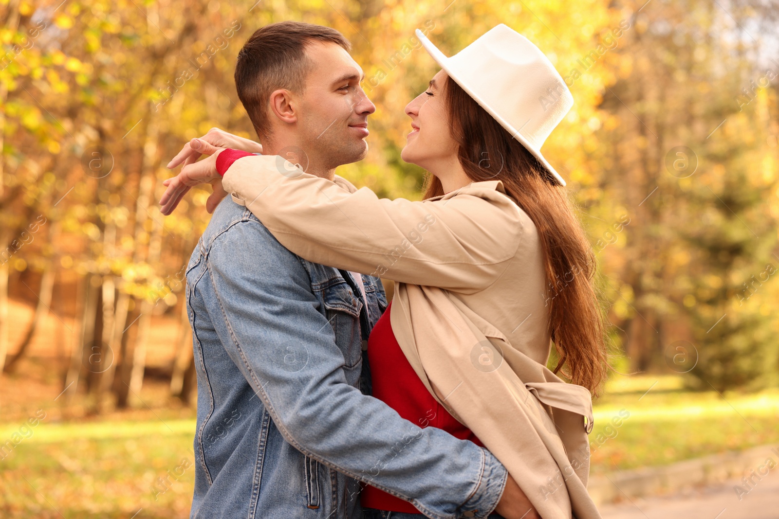 Photo of Happy couple spending time together in autumn park