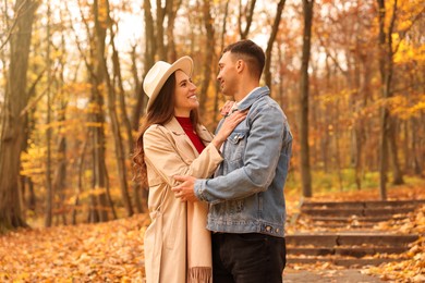 Photo of Happy couple spending time together in autumn park