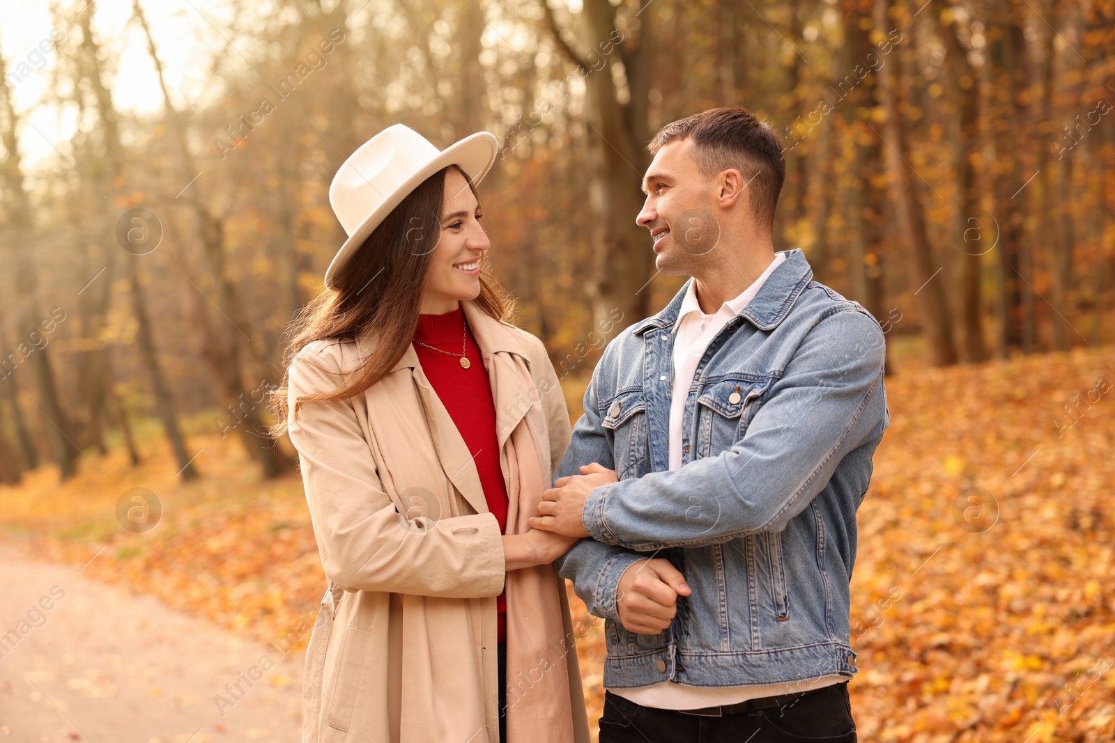 Photo of Happy couple spending time together in autumn park