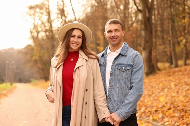 Photo of Happy couple spending time together in autumn park