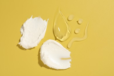 Photo of Samples of different cosmetic products on yellow background, flat lay