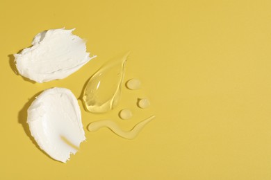 Samples of different cosmetic products on yellow background, flat lay. Space for text