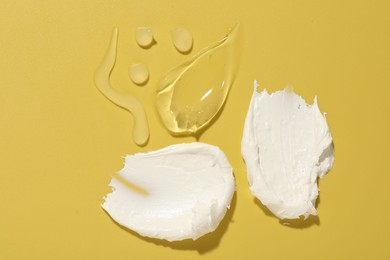 Photo of Samples of different cosmetic products on yellow background, flat lay