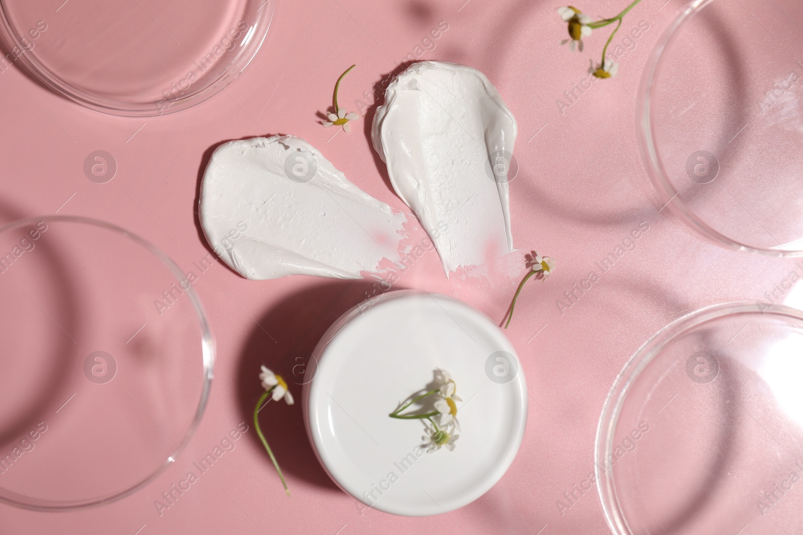 Photo of Stylish presentation of cream on pink background, flat lay