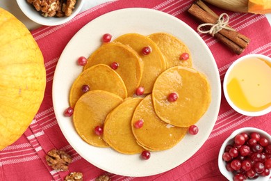 Photo of Tasty pumpkin pancakes served on table, flat lay