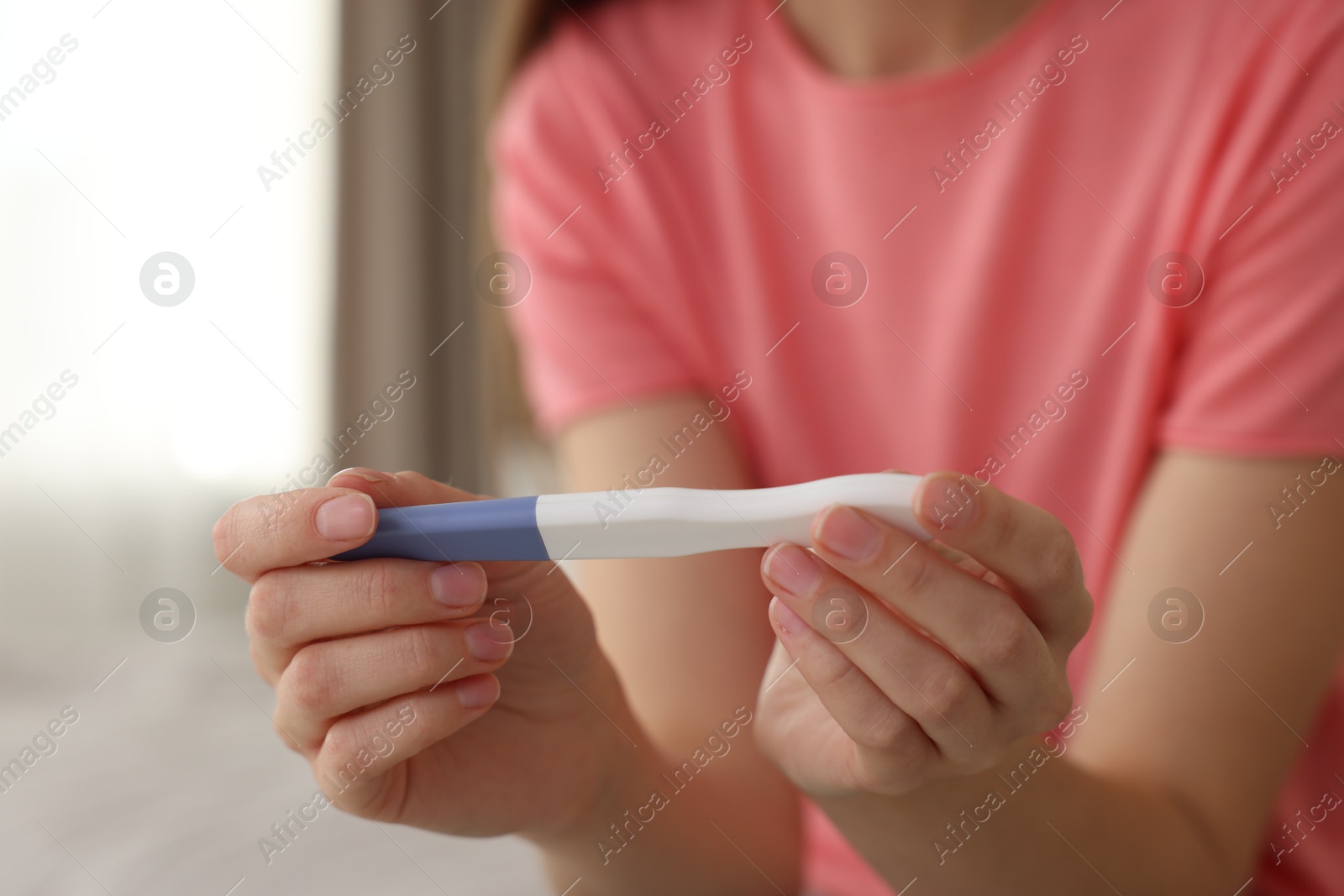 Photo of Woman with negative pregnancy test at home, closeup