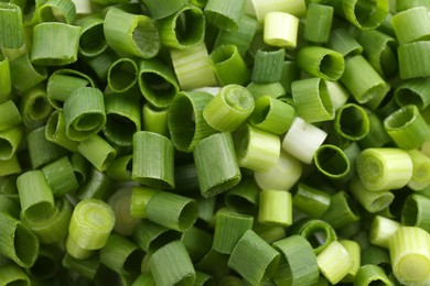 Photo of Chopped fresh green onion as background, closeup