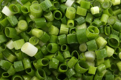 Photo of Chopped fresh green onion as background, top view