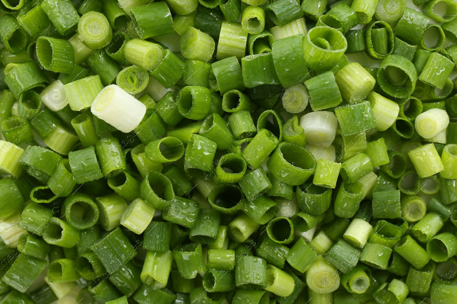 Photo of Chopped fresh green onion as background, top view