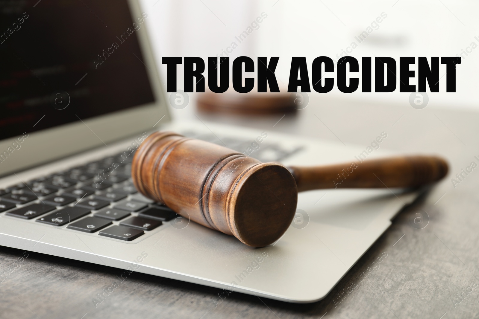 Image of Truck accident law. Laptop and judge's gavel on table indoors, closeup