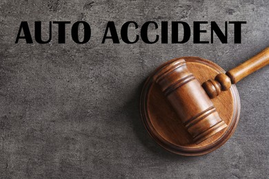 Image of Auto accident law. Judge's gavel on grey table, top view