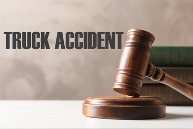 Image of Truck accident law. Wooden judge's gavel and books on table