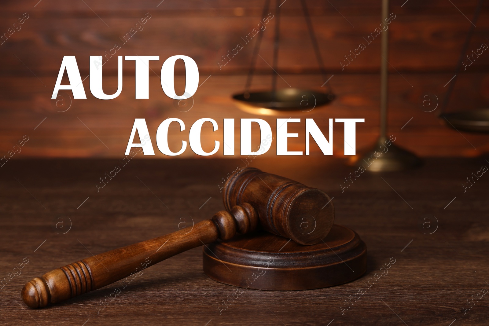 Image of Auto accident law. Judge's gavel and scales of justice on wooden table