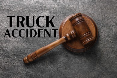 Image of Truck accident law. Judge's gavel on grey table, top view