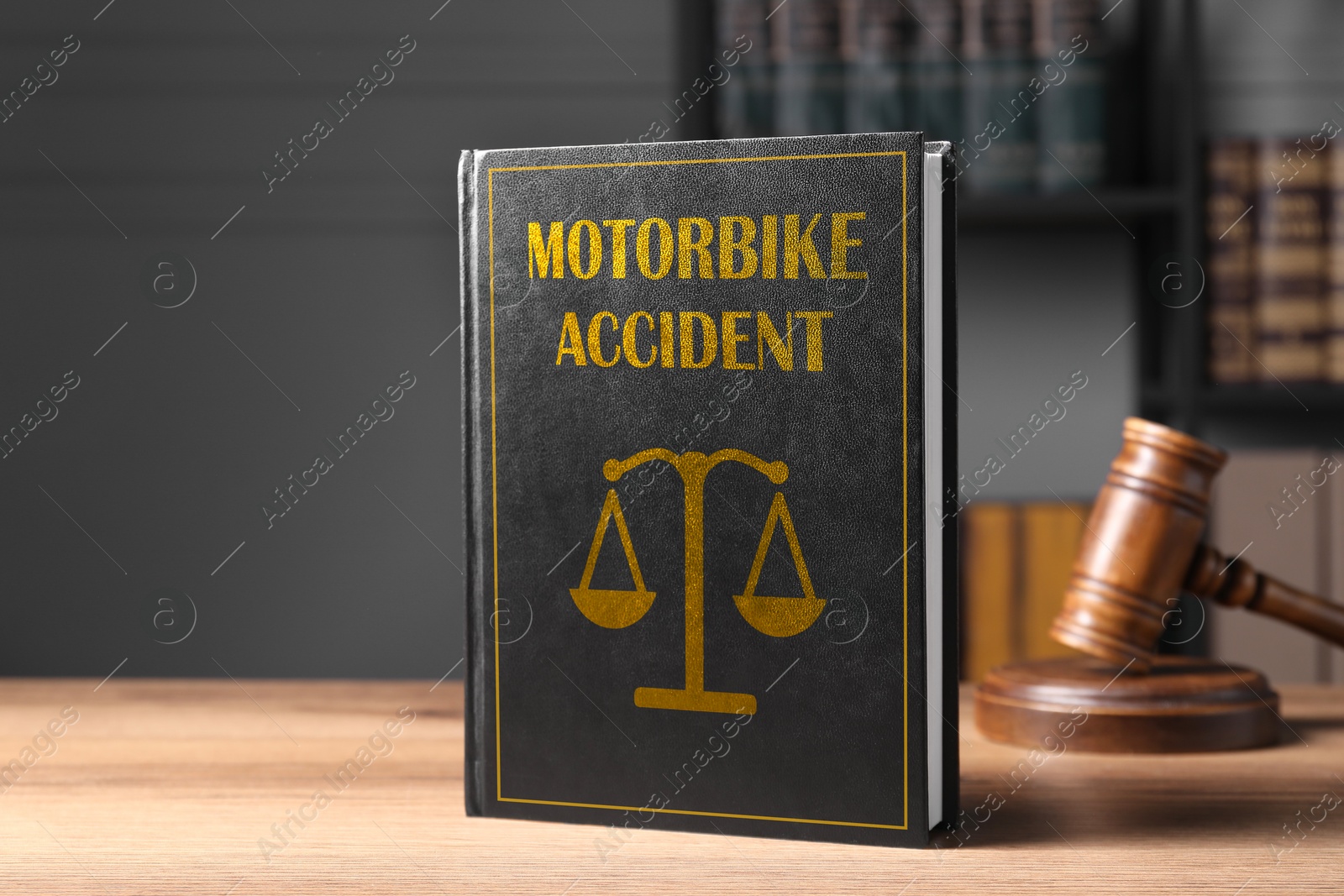 Image of Motorbike Accident law book and judge's gavel on wooden table, space for text