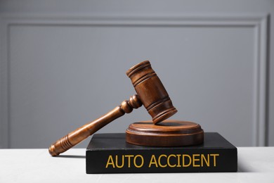 Image of Auto Accident law book and judge's gavel on light table