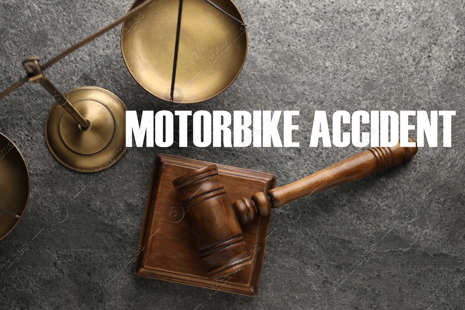 Image of Motorbike accident law. Judge's gavel and scales of justice on dark grey table, top view