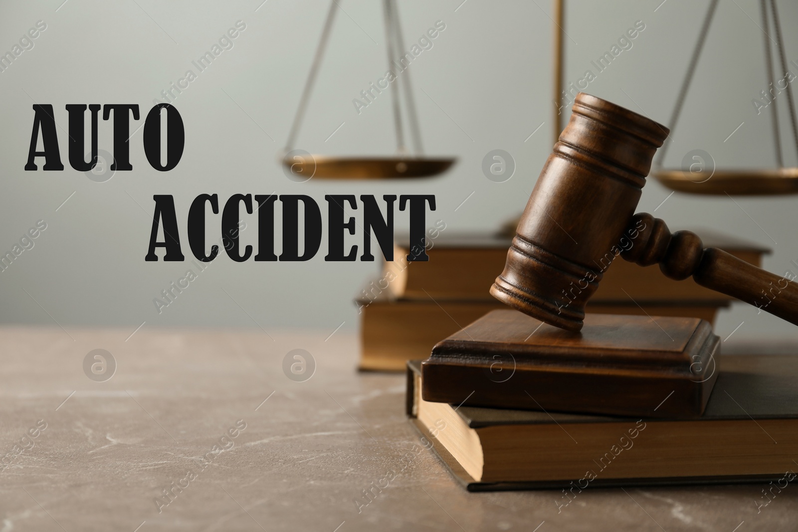 Image of Auto accident law. Wooden judge's gavel, scales of justice and books on table