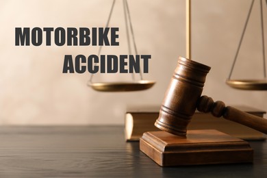 Image of Motorbike accident law. Wooden judge's gavel, scales of justice and book on table