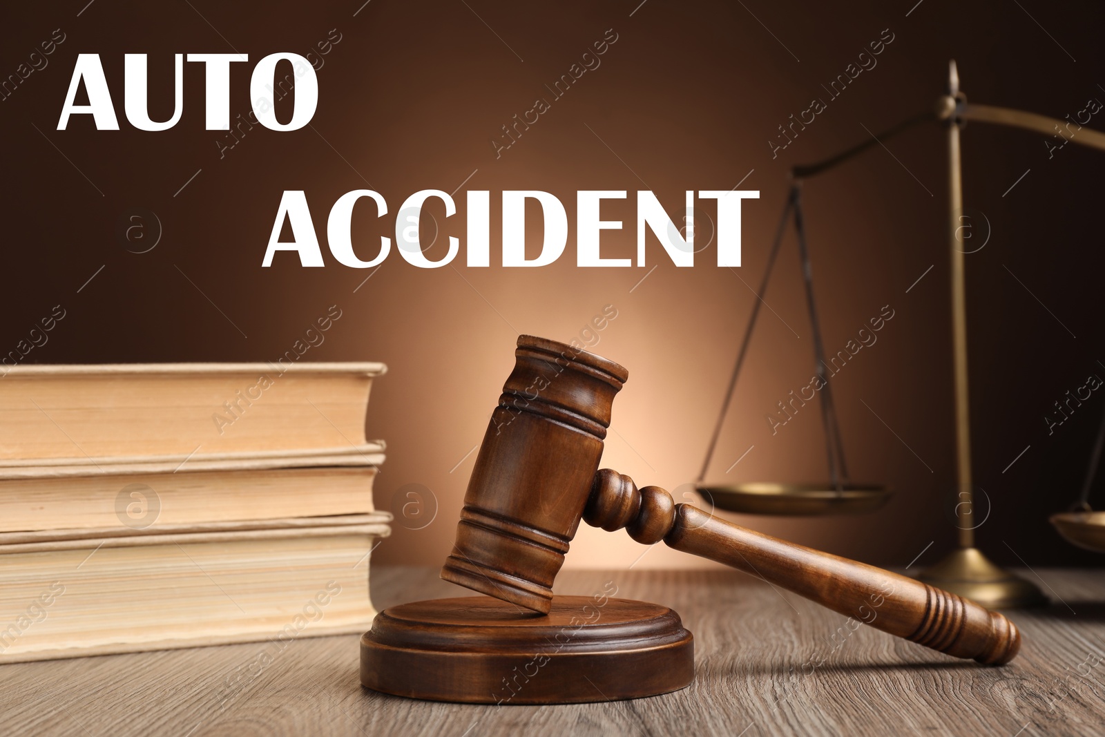 Image of Auto accident law. Judge's gavel, scales of justice and books on wooden table against brown background