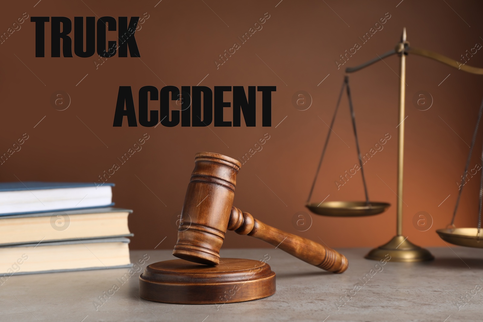 Image of Truck accident law. Judge's gavel, scales of justice and books on table against brown background