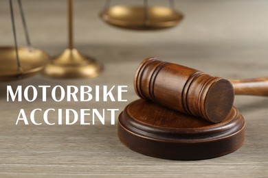 Image of Motorbike accident law. Wooden judge's gavel on table