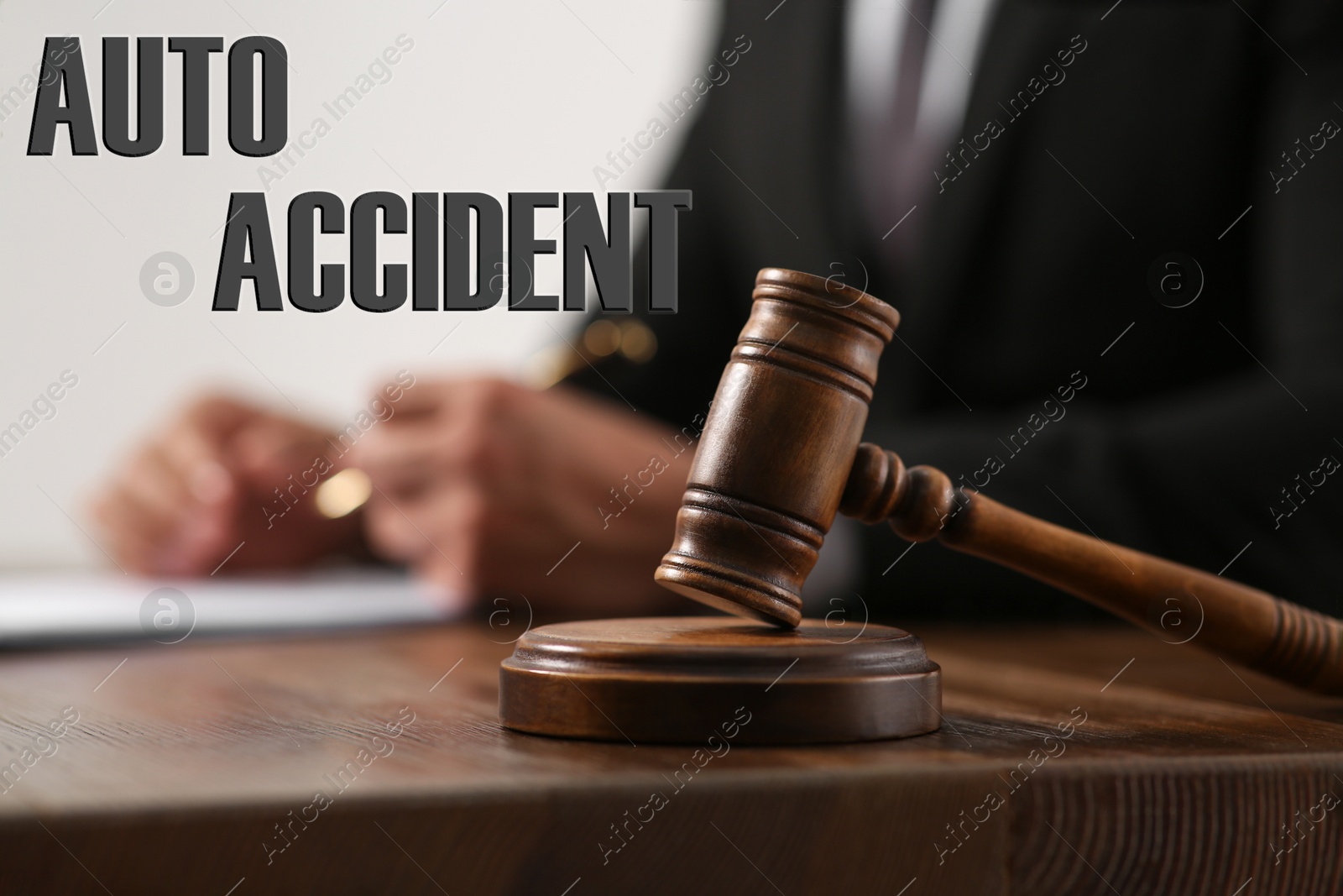 Image of Auto accident law. Judge at wooden table, focus on gavel