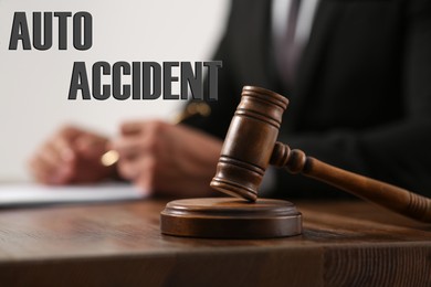 Image of Auto accident law. Judge at wooden table, focus on gavel