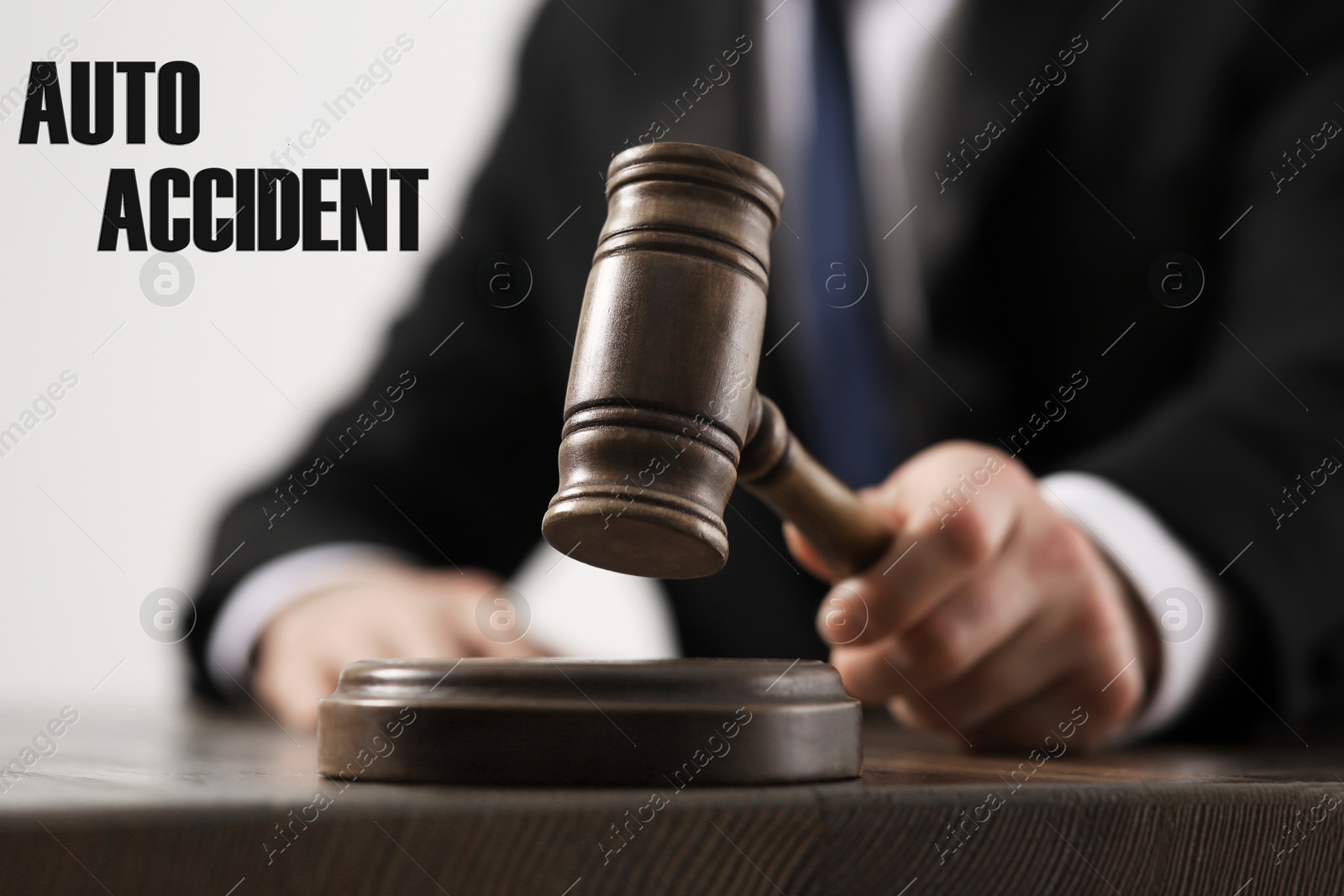 Image of Auto accident law. Judge with gavel at wooden table, closeup