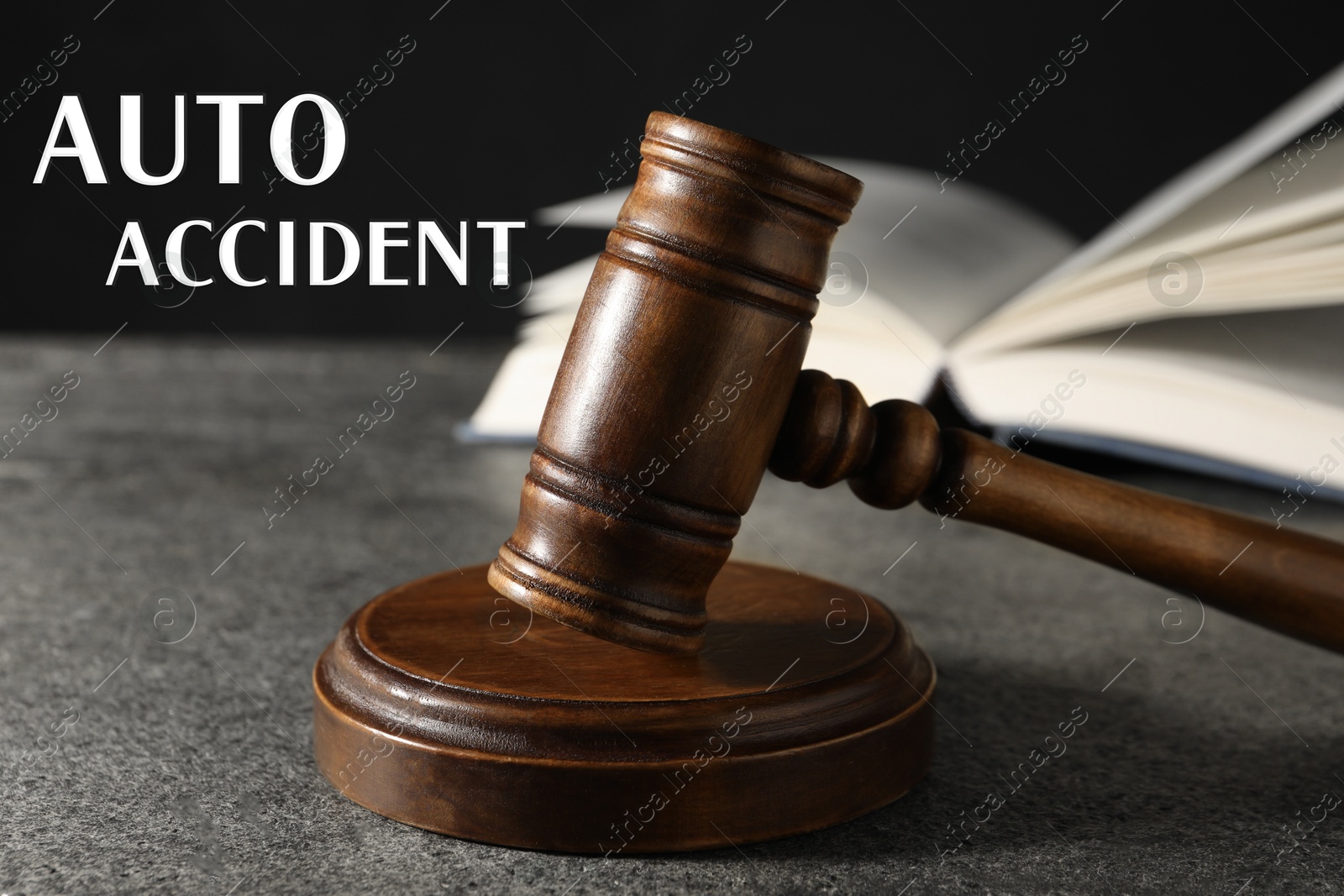 Image of Auto accident law. Judge's gavel and book on grey table