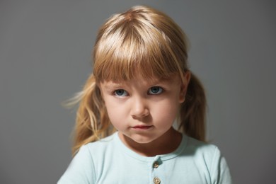 Photo of Orphanage concept. Sad little girl on grey background