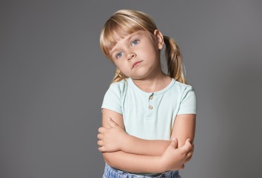 Photo of Orphanage concept. Sad little girl on grey background