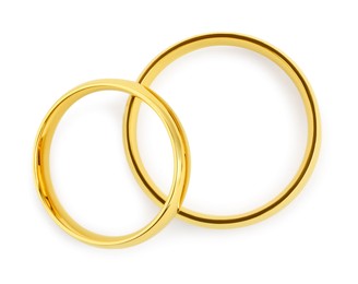 Photo of Beautiful golden wedding rings isolated on white, top view