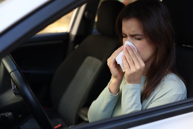 Photo of Young woman with runny nose in car