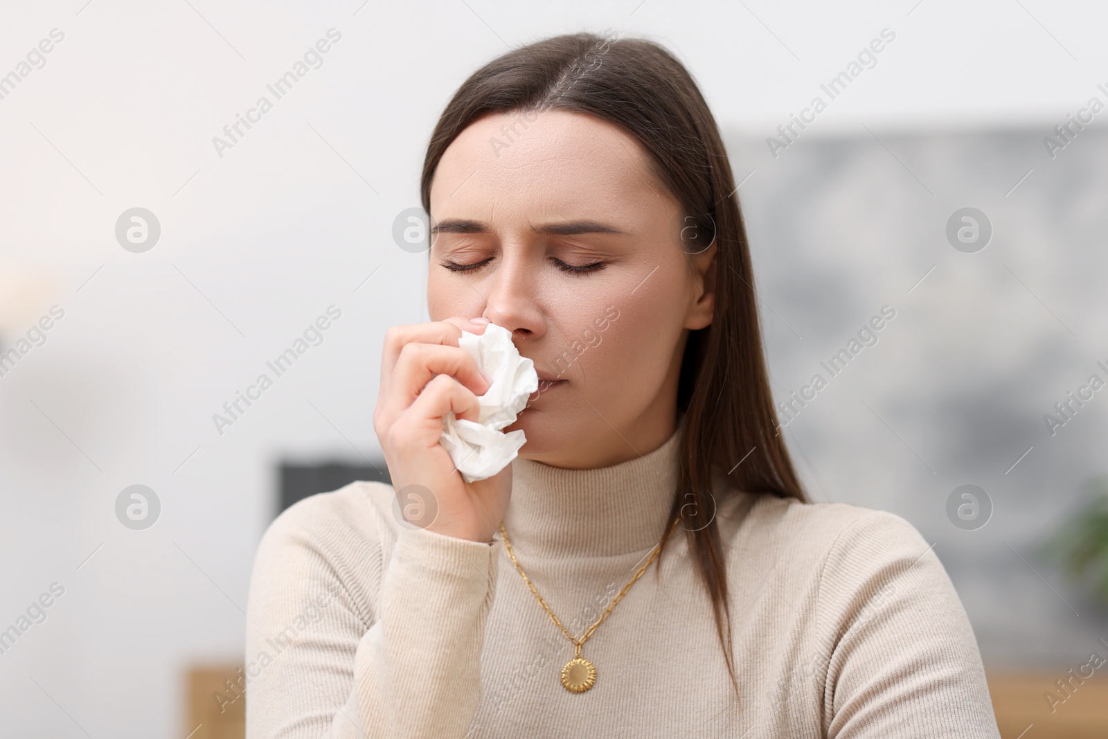 Photo of Sick woman with runny nose in office