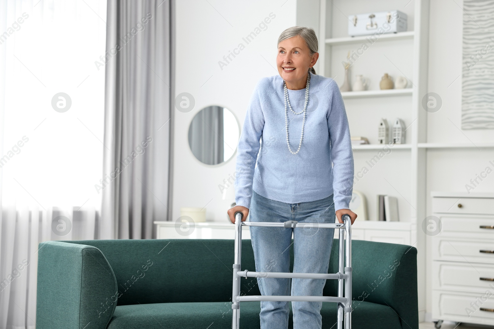 Photo of Senior woman with walking frame at home