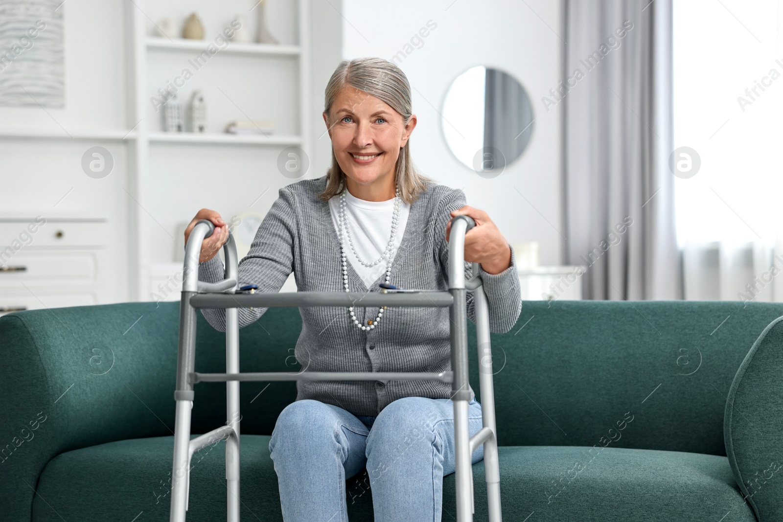 Photo of Senior woman with walking frame on sofa at home