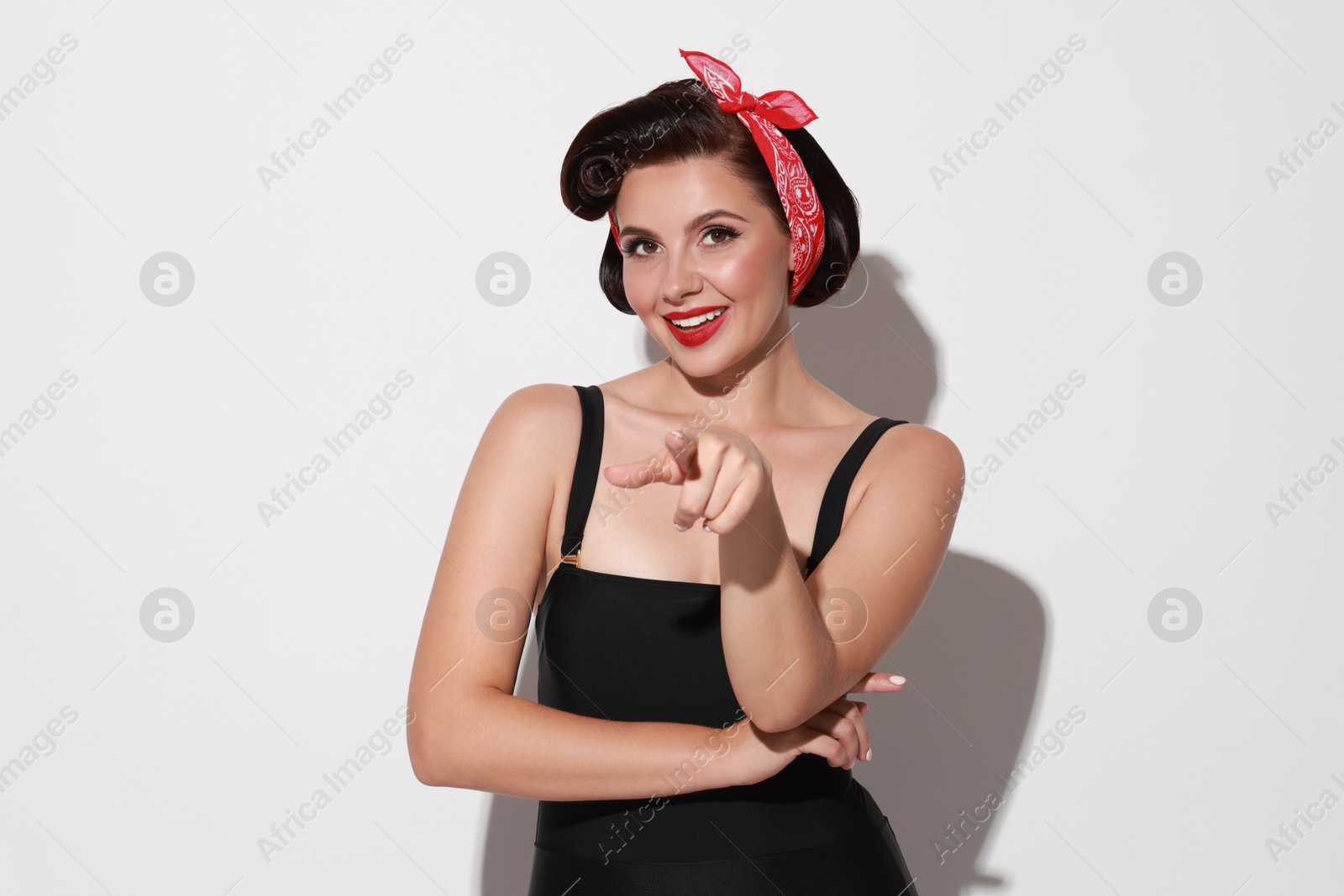 Photo of Portrait of pin-up woman on light background