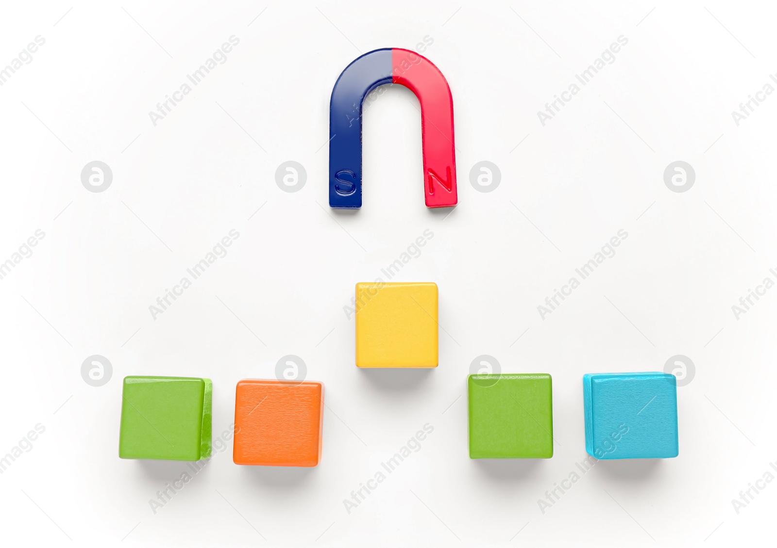 Photo of Magnet attracting colorful cubes on white background, flat lay