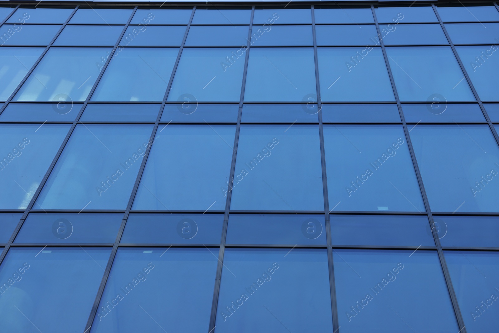 Photo of Exterior of modern building with many windows, low angle view